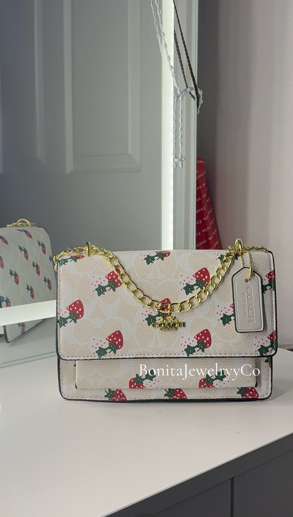 White strawberry purse with gold strap