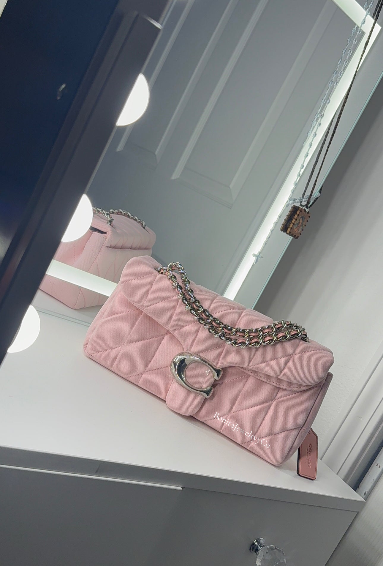 Pink cross body purse with silver wear