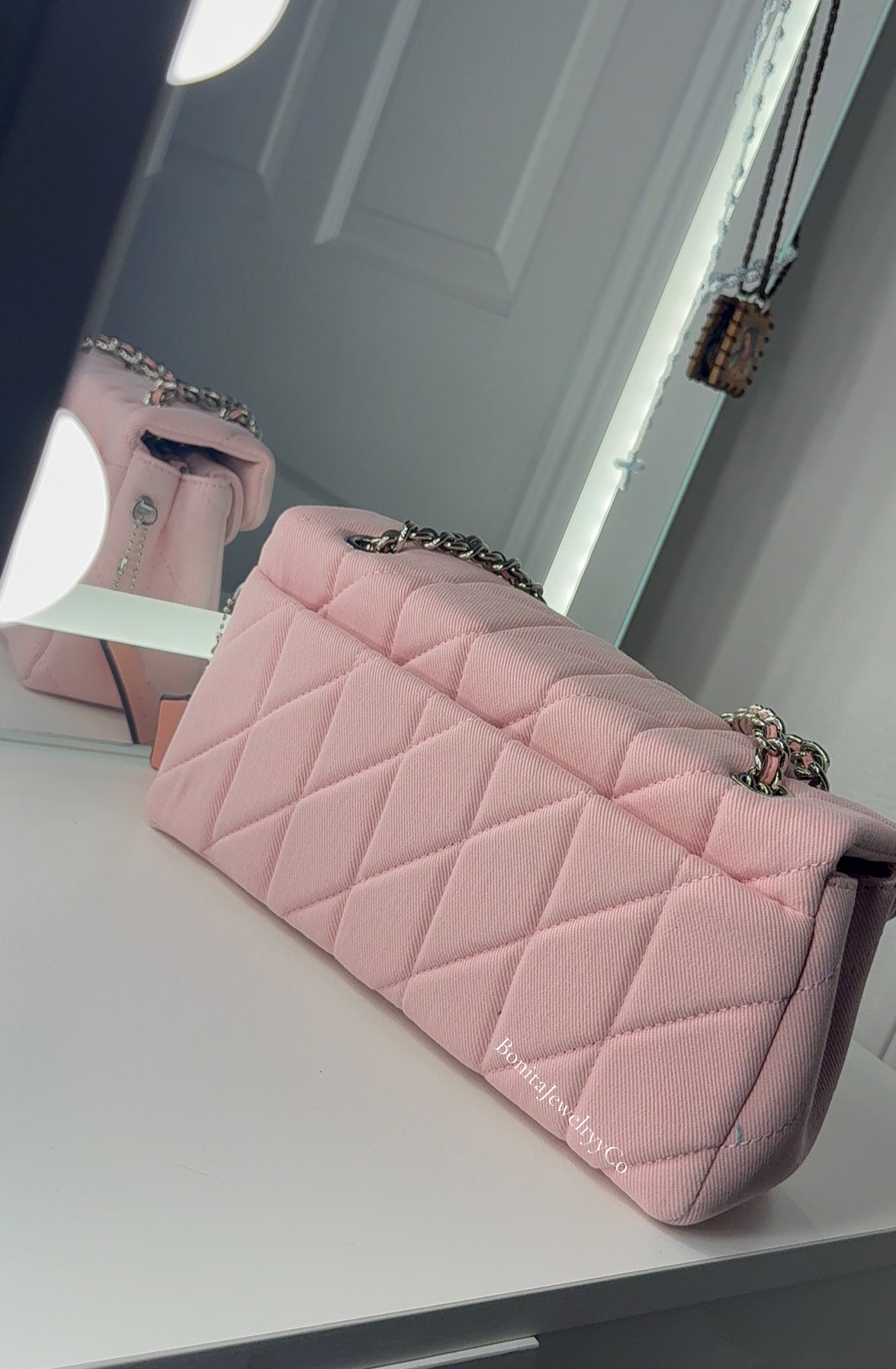 Pink cross body purse with silver wear