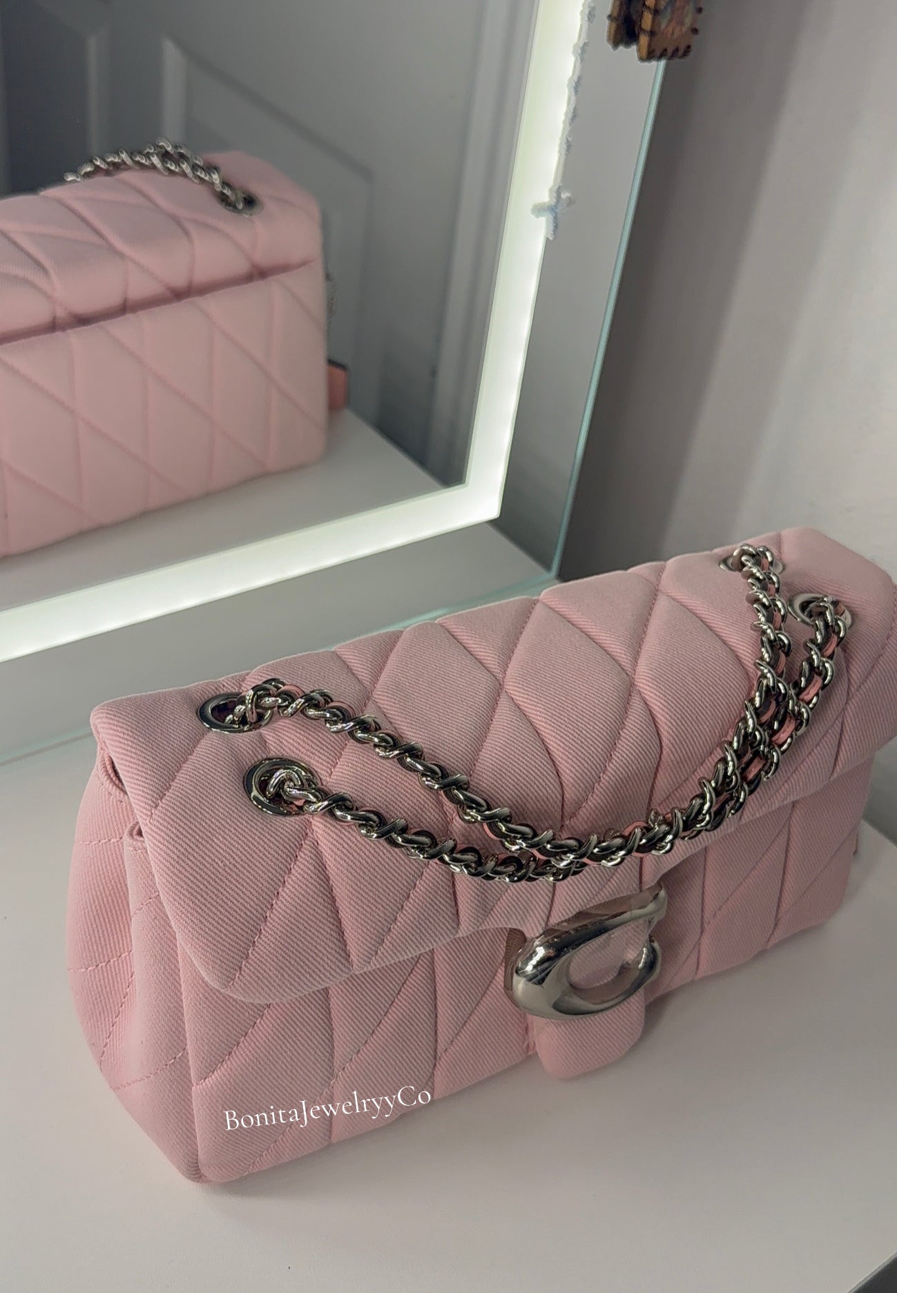 Pink cross body purse with silver wear
