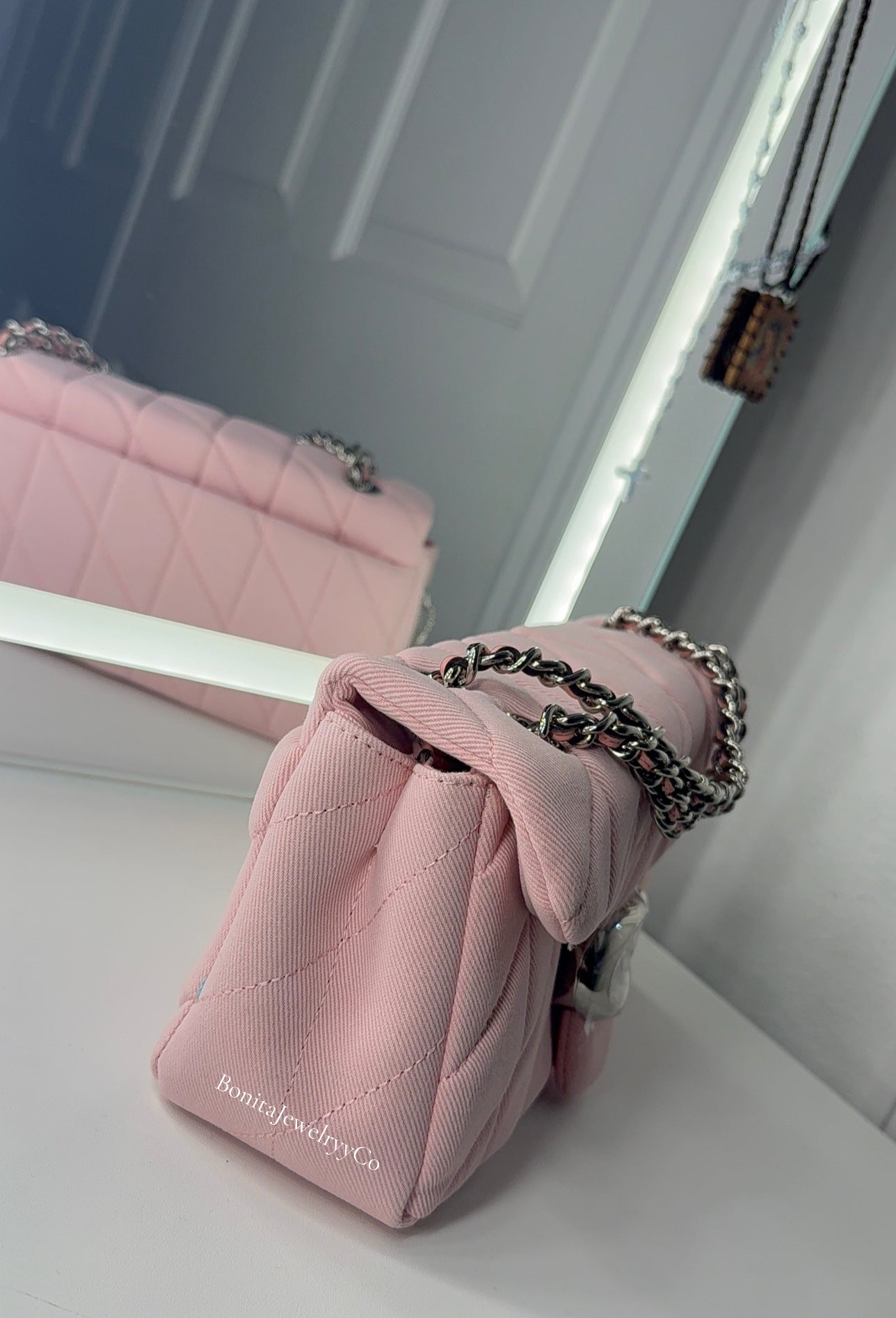 Pink cross body purse with silver wear