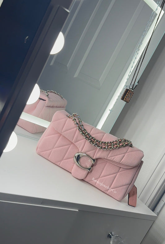 Pink cross body purse with silver wear