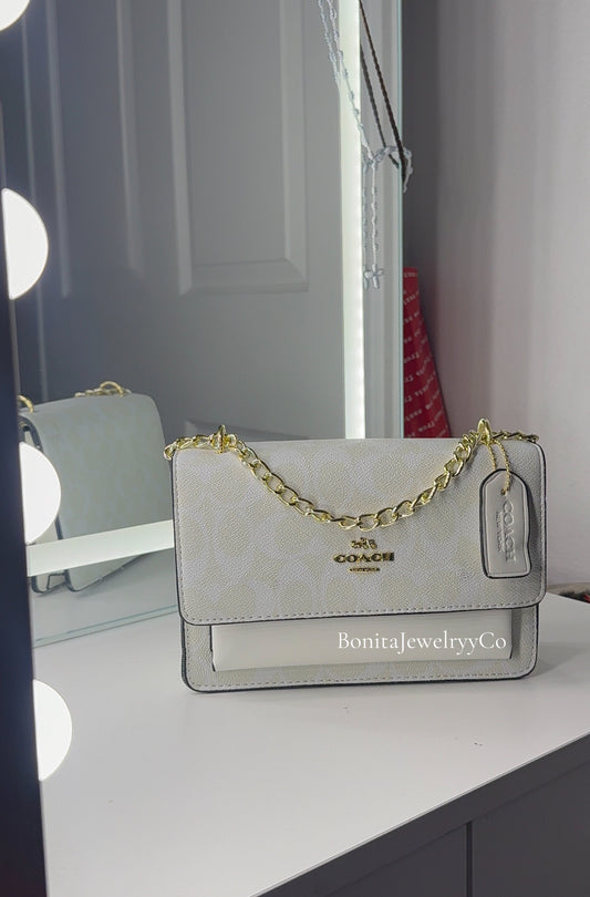 All white purse with gold strap