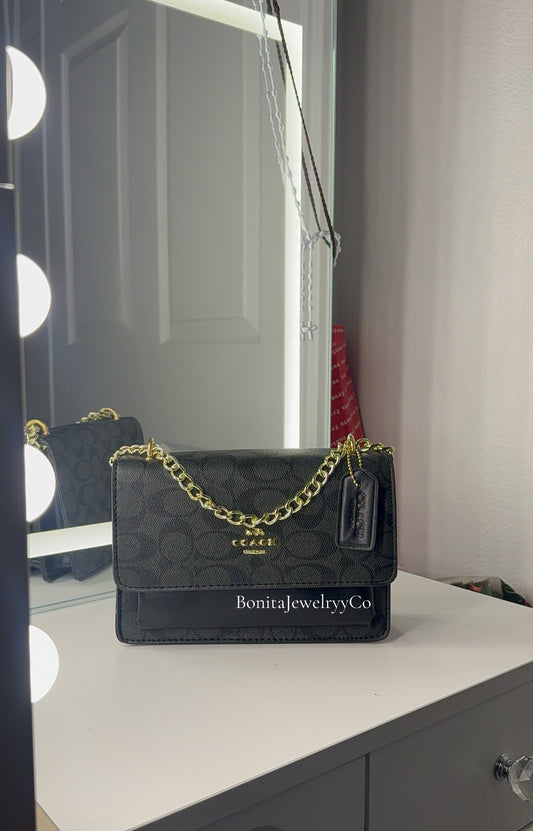 Black purse with gold strap